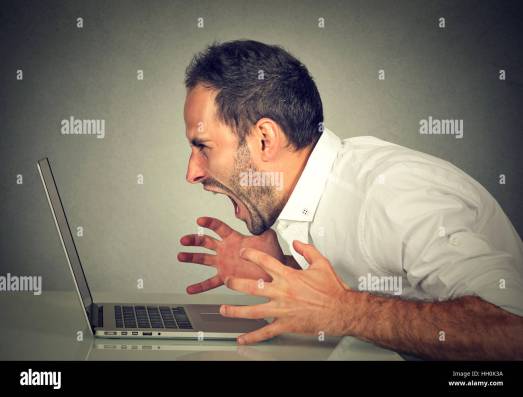 angry-furious-business-man-screaming-at-computer-negative-human-emotions-HH0K3A